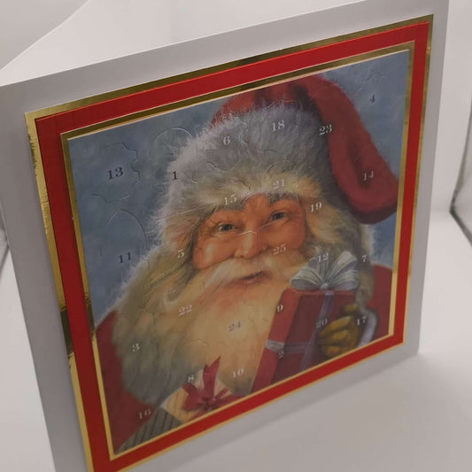 Vintage-style Santa Advent Calendar with red and gold border, photographed upright on a white background to show depth and card structure.